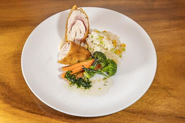 delicious cordon bleu dish, breaded chicken dish stuffed with cheese and ham, accompanied by mashed potatoes and salad