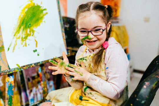 Color painting for disabled kids, child who are down syndrome and student teacher, development of children with special needs.