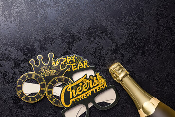 Happy new year background. Black funny paper glasses and bottle of champagne on black table. Top...