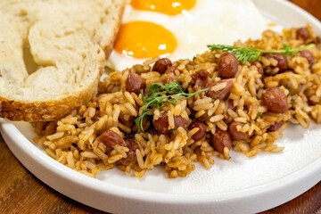 Colombian breakfast with bread, eggs and warmed rice