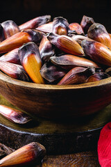 pine nuts in rustic wooden bowl, traditional brazilian winter food