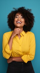 happy black woman with yellow shirt and a blue background