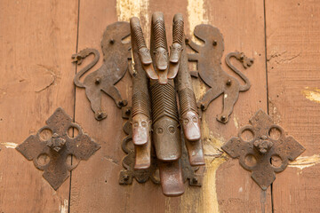 Antique door handle in the shape of a snake on an old wooden door in Albarracín (Spain).