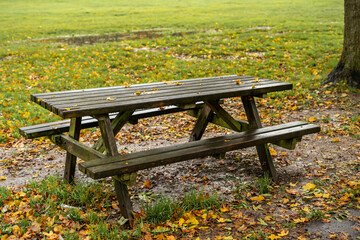 Picnic table in a public park during autumn season