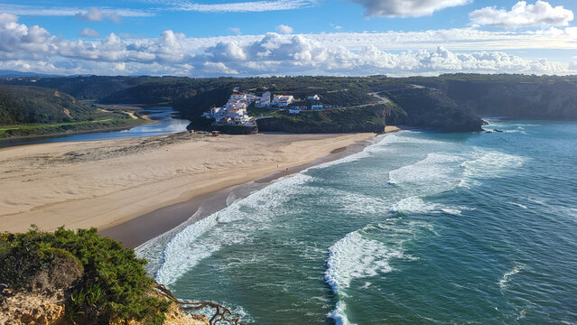 Praia De Odeceixe Mar Beach With Golden Sand, Atlantic Ocean, River Bend and White Houses of Odeceixe Village. Rota Vicentina Coast, Odemira, Portugal. Hiking Rota Vicentina the Fisherman's Trail