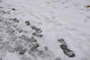 footprints in the snow in the city, ozheliditsya, winter in the city 
