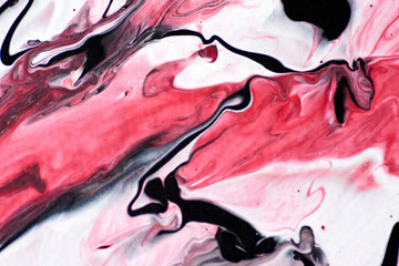 Marbled acrylic colored pattern in the colors red, black, white and pink.