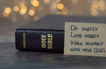 Do justly, love mercy, walk humbly with your God, handwritten biblical quote, Micah 6:8 and holy bible with bokeh background. Christian biblical concept of humility and obedience to Jesus Christ. - obrazy, fototapety, plakaty