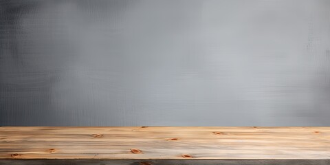 Gray background with empty wooden table top, used for displaying or arranging products.