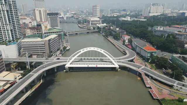 Aerial perspective of a tied-arch bridge spanning the Pasig River and connecting Binondo and Intramuros districts of Manila, Philippines