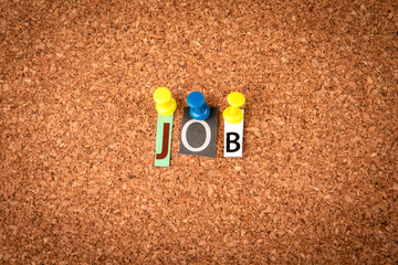 JOB. Letters pinned to a cork notice board
