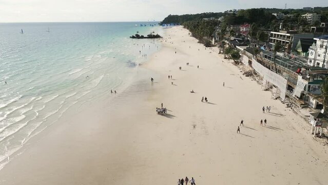 Aerial footage of a tropical sandy beach located on Boracay island, Philippines