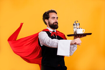 Superhuman butler with cape and platter, serving food at five star restaurant on camera. Young...