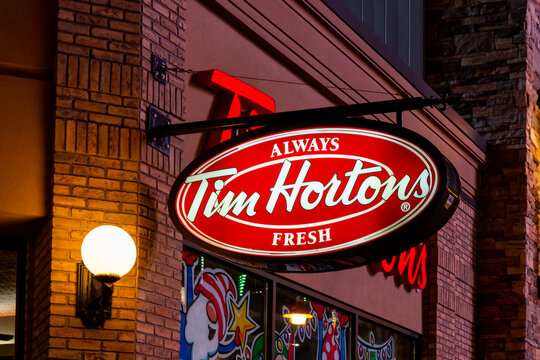 
Tim Hortons logo sign on the building at dusk. Niagara Falls, Ontario, Canada, on December 8, 2023. Tim Hortons Inc., is a Canadian multinational coffeehouse and restaurant chain.
