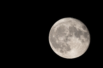 Full moon photographed with a telescope and reflex camera where the craters on the lunar surface can be seen. The seventh continent will be the destination for space travel and future moon landings