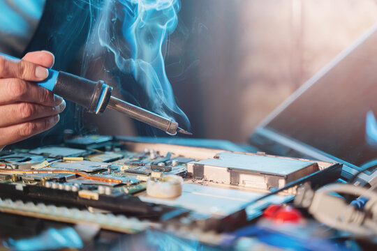 Close-up Of A Hand Repairman Specialist Man Repairs, And Repairing Electronics In A Hardware Repair Shop