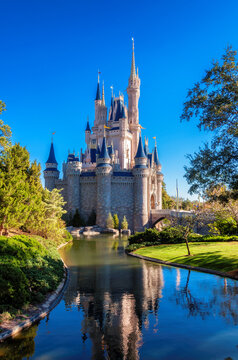 Cinderella Castle reflection on a pond in Walt Disney World Magic Kingdom in Orlando, Florida