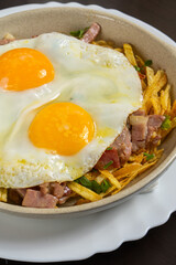 Broken eggs: a Spanish dish of fried eggs on a bed of crispy potatoes and ham, a flavorful and comforting delicacy.