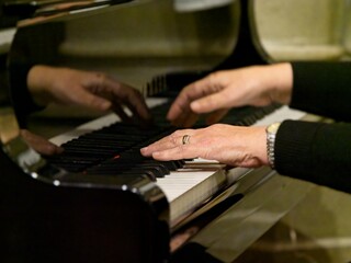 Woman's hands playing piano