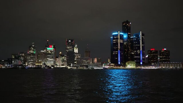 Time lapse of Detroit skyline viewed from Windsor ON at night with a cargo ship passing in front of it
