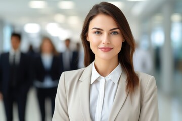 A woman in a business suit standing in front of a group of people.