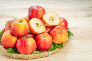 Sweet red star apple in basket on wooden table background,