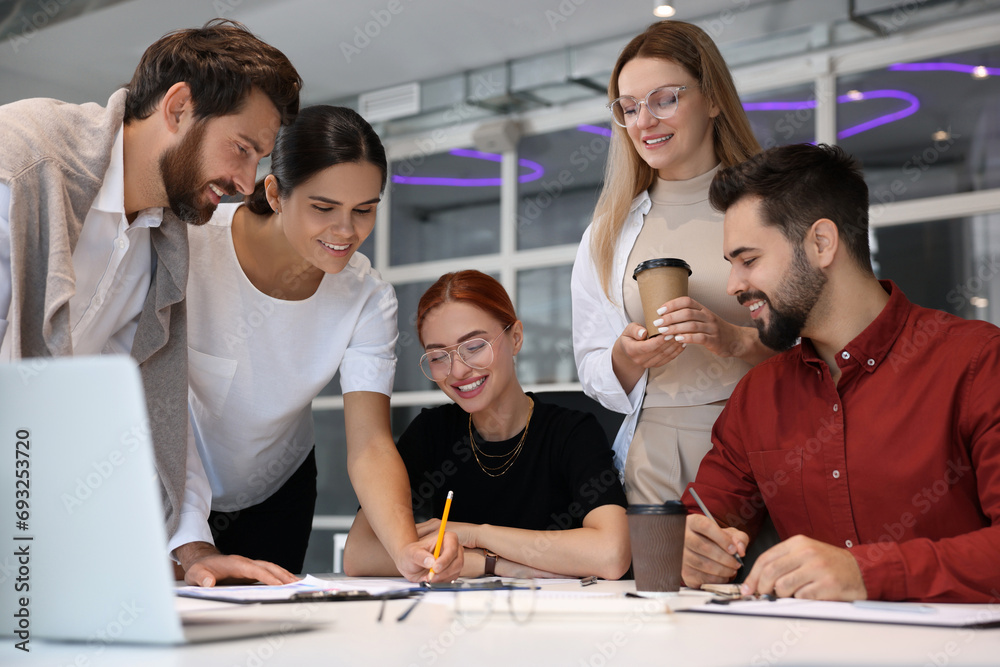 Wall mural Team of employees working together in office