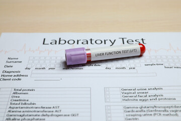 Liver Function Test. Tube with blood sample and laboratory form on table
