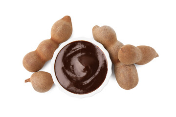 Bowl of tasty tamarind sauce and fresh pods isolated on white, top view