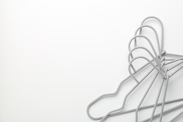 Hangers on white background, top view. Space for text