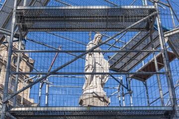 religious historical statue covered with iron frames for protection in lviv old city