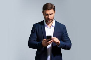 Business man in suit talking on phone, promo mobile app. Businessman in casual clothes using smartphone isolated on studio background. Portrait of cheerful guy using cellphone, browse social media.