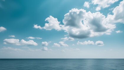 Fototapeta na wymiar A beautiful blue sky with clouds and the ocean below