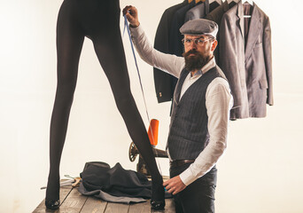Male dressmaker. Retro old fashion dressmaker measure female sexy long legs. Man seamstress....