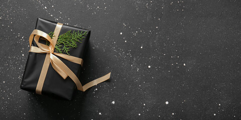 Christmas gift box on black background with space for text, top view