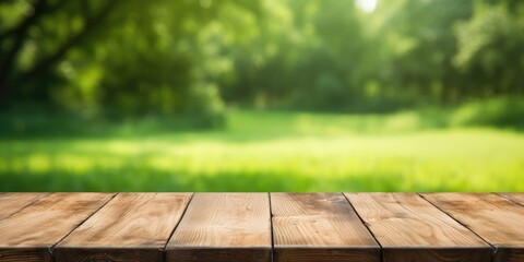 Wooden table on green yard background with empty space for copying