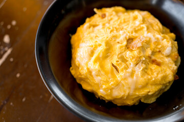 Condensed egg rice in black bowl. Delicious morning food