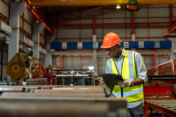 African American industrial worker is checking the setup value of metal sheet roll forming machine...