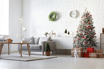 Stylish interior of living room with beautiful Christmas tree and gifts