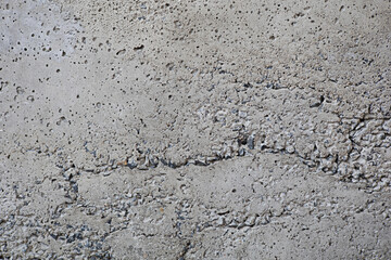 Concrete surface mixed with stone cracks