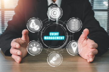 Fototapeta na wymiar Event management concept, Businessman hand holding event management icon on virtual screen, scheduling, creativity, budget, location, coordinating, marketing, logistics.