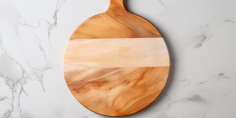 Top view of a round wooden serving board with handle on a marble table. Kitchenware, template with copy space. Flat lay design, mockup. Cooking concept.