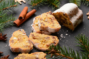 Composition with tasty Christmas stollen on black background