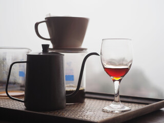 A coffee maker sitting on a counter next to a cup.