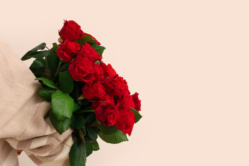 Young woman with bouquet of beautiful red roses on white background. Valentine's day celebration