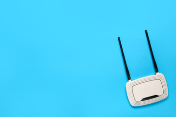 Modern wi-fi router on blue background