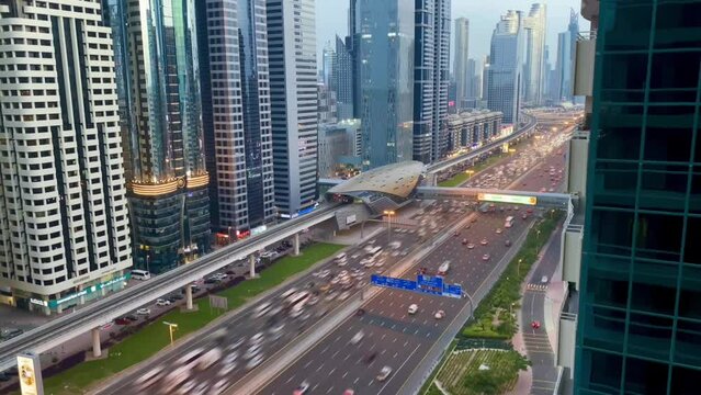 Timelapse featuring Sheikh Zayed Road. Cars weave through the city's heartbeat, framed by skyscrapers at sunset