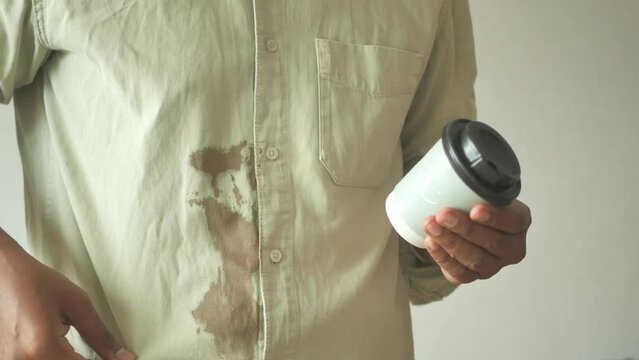  men hands with spilled coffee over his shirt