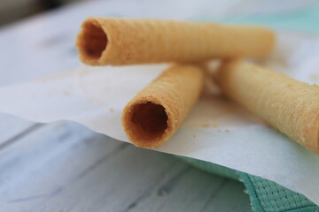 Egg roll in a plate on a table covered with a green tablecloth