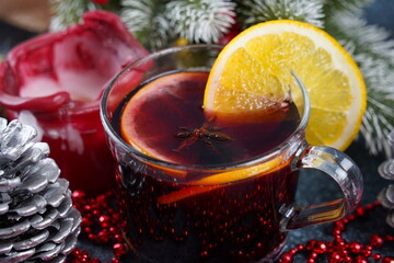Christmas mulled red wine with spices and fruits on a table. Traditional hot drink at Christmas time